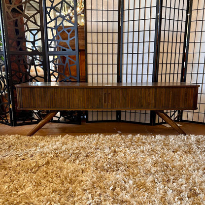 Wooden console table in a room with decorative screen and rug