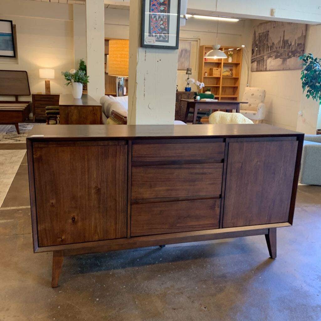 Wooden sideboard in a room with furniture and decor
