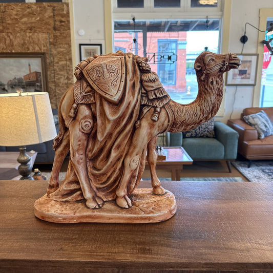 Camel statue on a wooden table in a living room setting