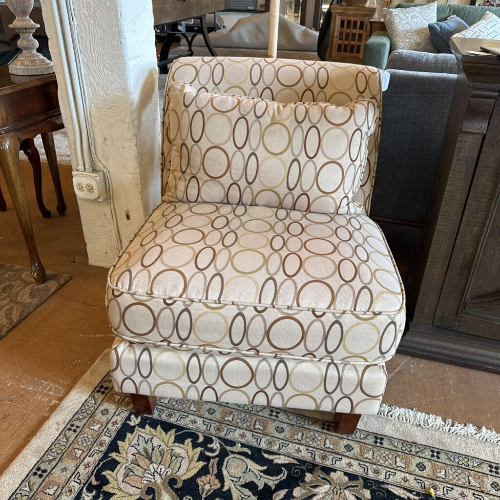 Patterned armchair in a living room setting with furniture and decor.