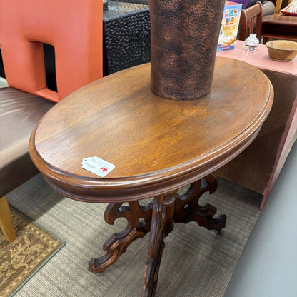 Wooden table with a tag on a carpeted floor
