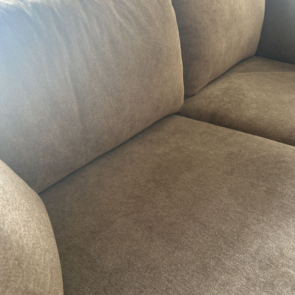 Brown sofa with a close-up view of the fabric texture.