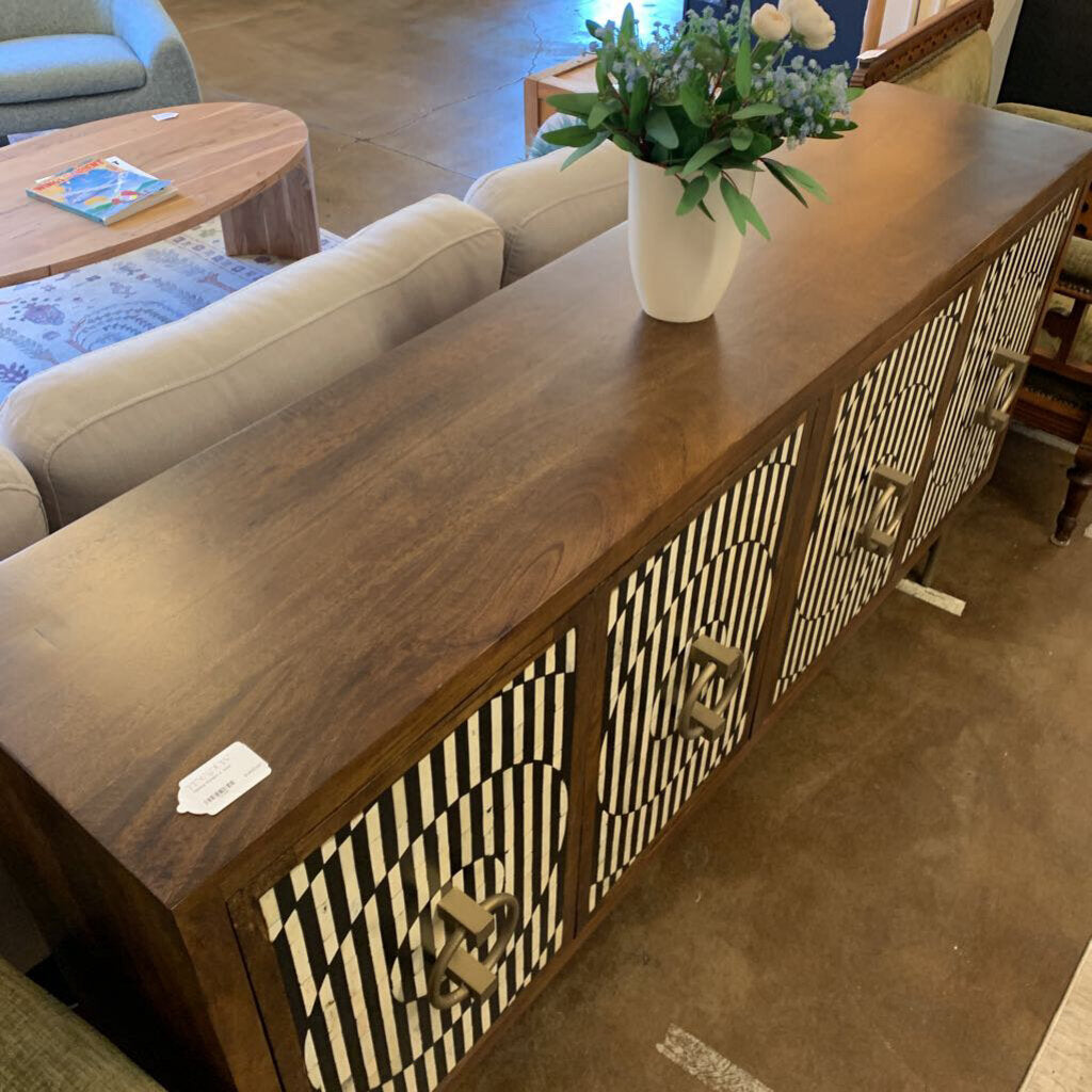 Wooden sideboard with decorative drawers in a living room setting