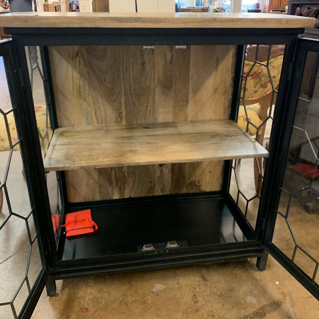 Wooden shelf with black metal frame on a store floor