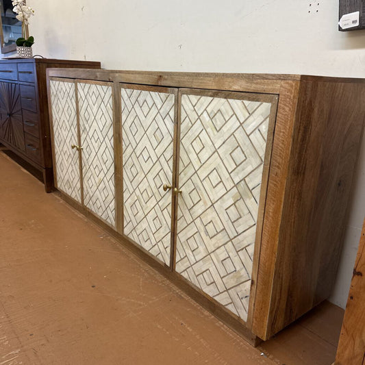 Wooden cabinet with patterned glass doors in a room setting