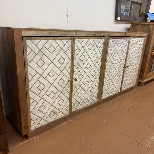 Wooden cabinet with patterned glass doors in a room setting