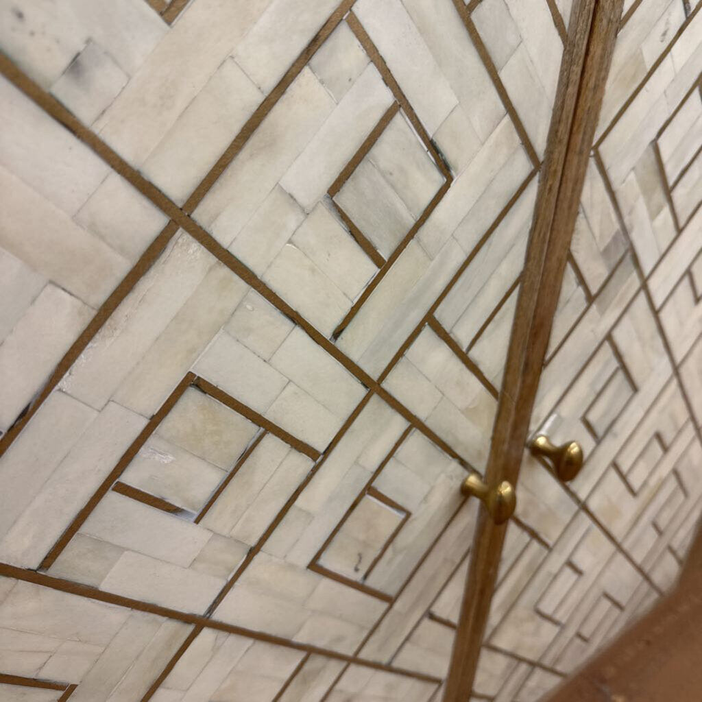 Close-up of a tiled wall with geometric pattern and gold border