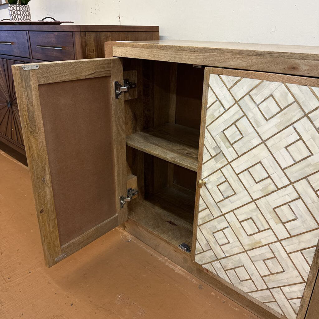 Wooden cabinet with open door revealing geometric patterned interior.