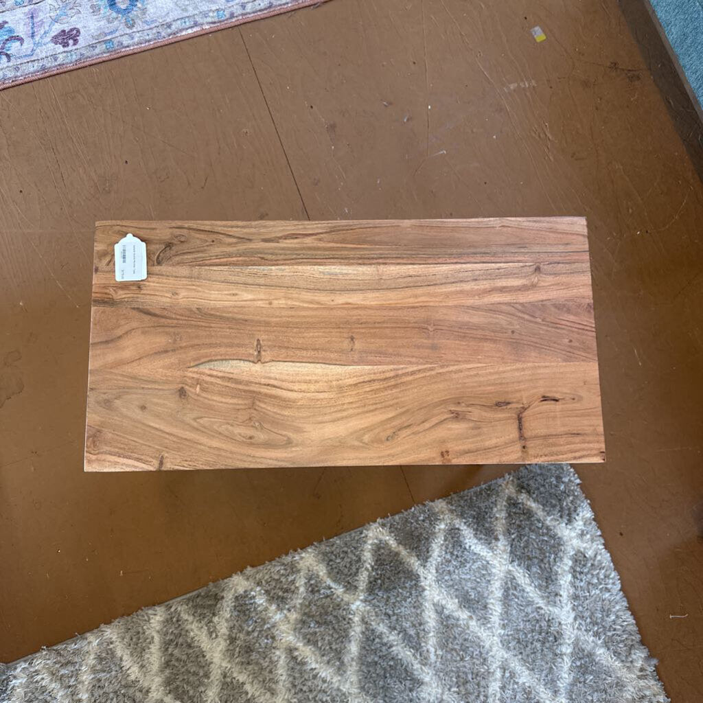 Wooden plank with a visible tag on a brown surface