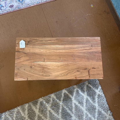 Wooden plank with a visible tag on a brown surface