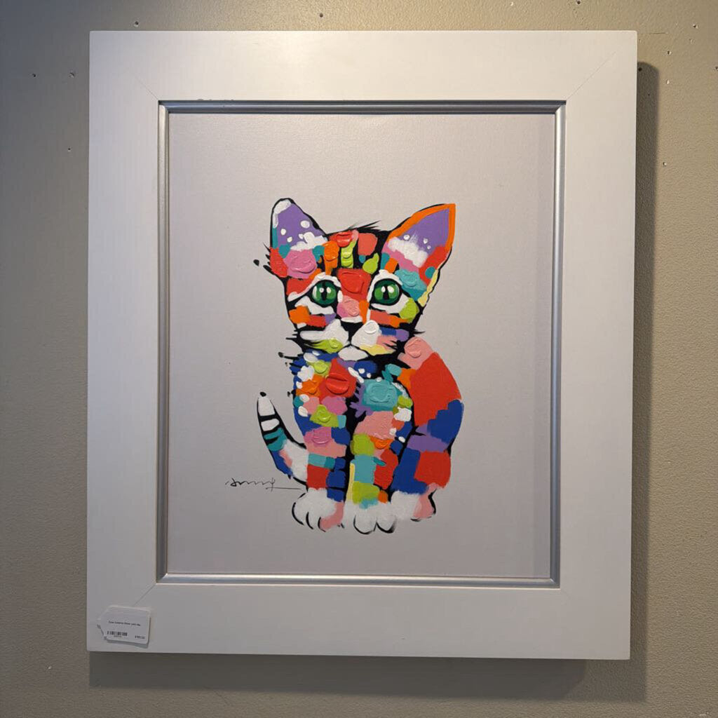Framed colorful cat artwork on a gray wall