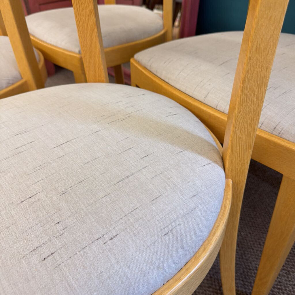 Close-up of a chair with wooden frame and quilted cushion seat.