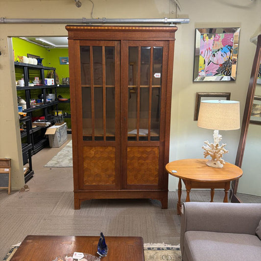 Wooden cabinet in a room with a lamp and sofa