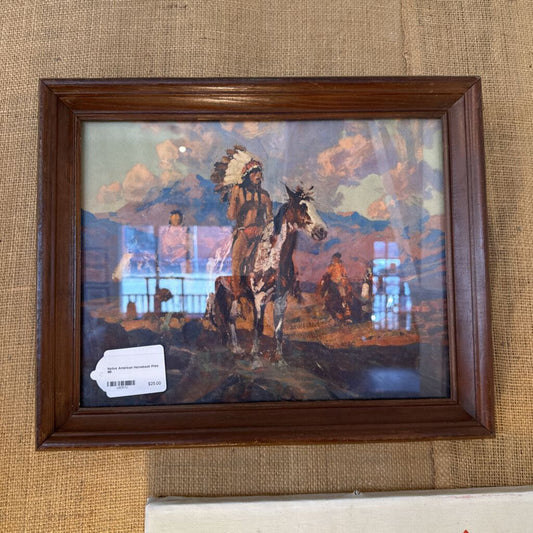 Framed painting of a Native American on horseback with a scenic background