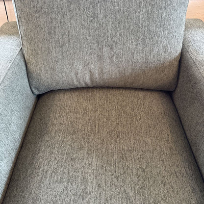 Gray upholstered chair with a textured fabric