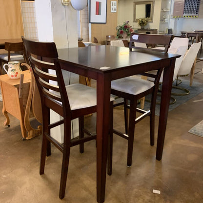 Wooden dining table with chairs in a showroom setting
