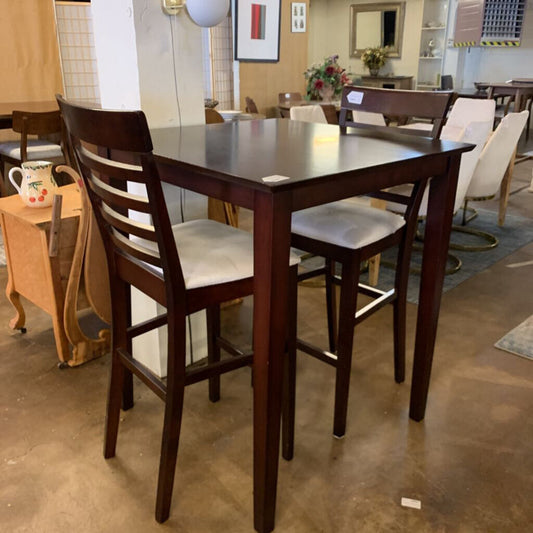Wooden dining table with chairs in a showroom setting