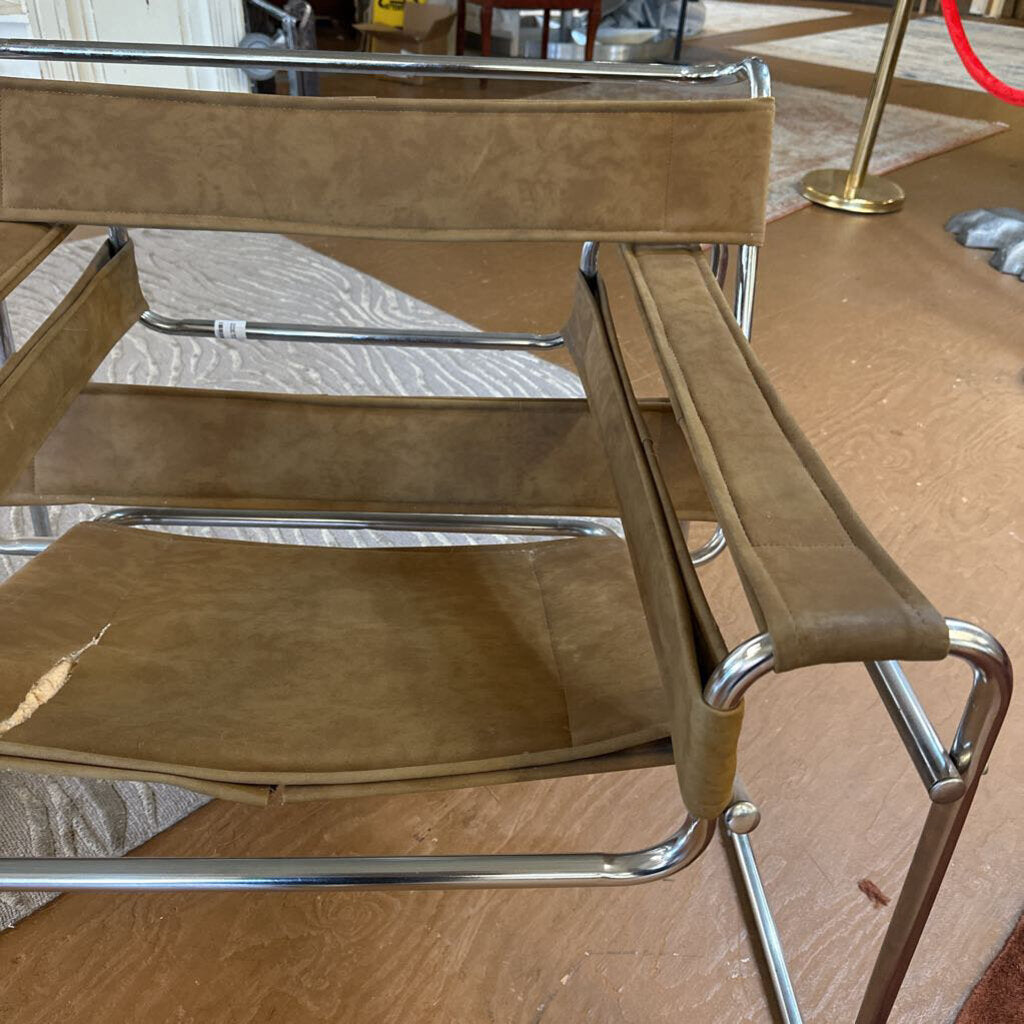 Brown chair with metal frame on a wooden floor