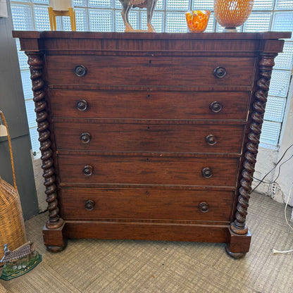 Wooden dresser with spiral legs in a room setting