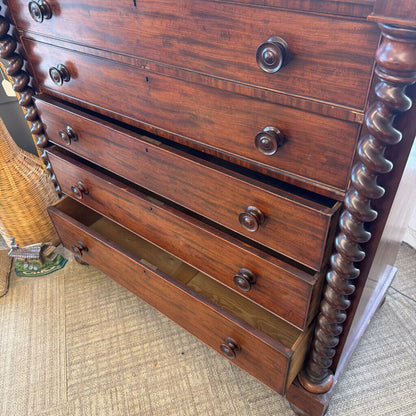 Wooden dresser with decorative carvings on a carpeted floor