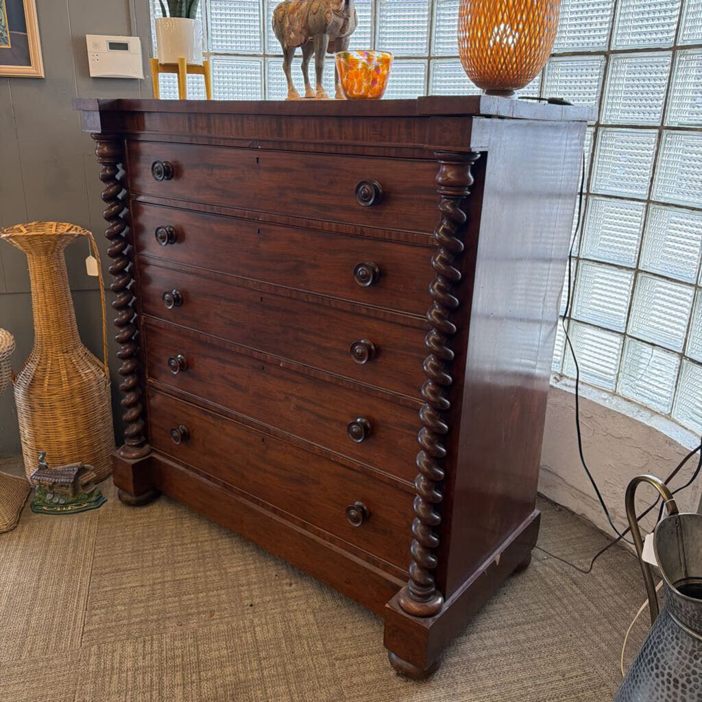 Wooden dresser with decorative elements in a room setting