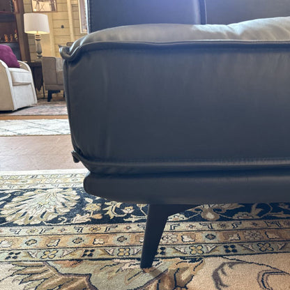 Gray sofa on a patterned rug in a living room setting