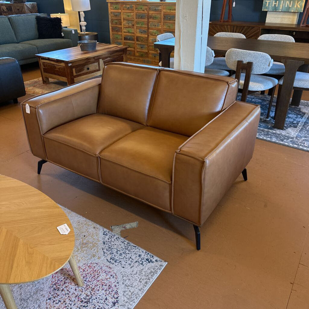 Brown leather sofa in a room with other furniture