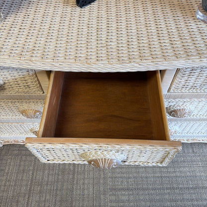 Wicker side table with a drawer open, showing a shell design.