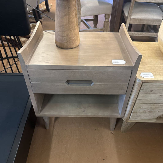 Wooden nightstand with a drawer in a store setting