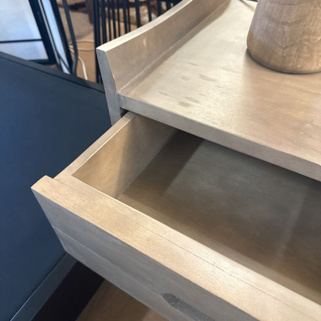 Wooden drawer being pulled out from a cabinet with a blurred background