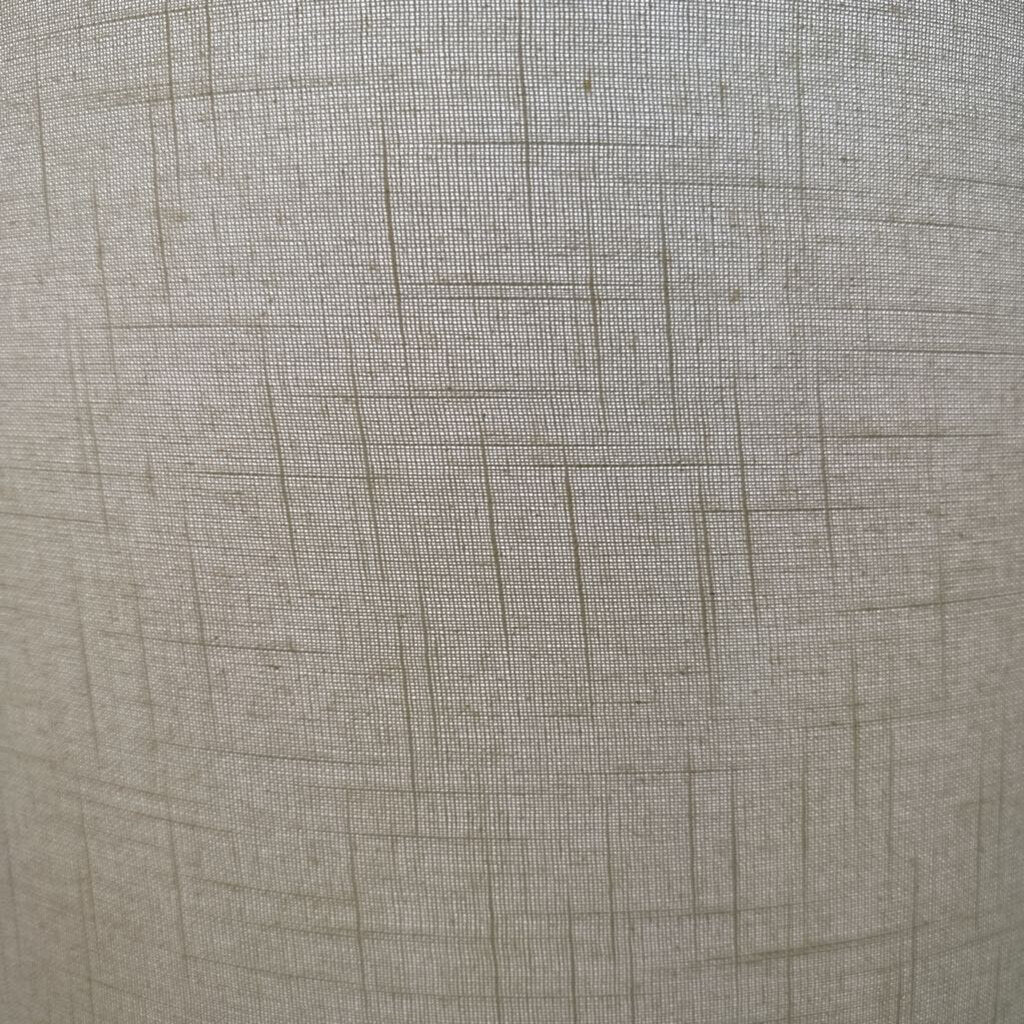 Close-up of textured beige fabric with a subtle pattern