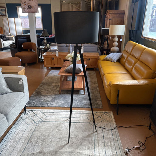 Living room with a yellow sofa, gray armchair, and a black floor lamp.