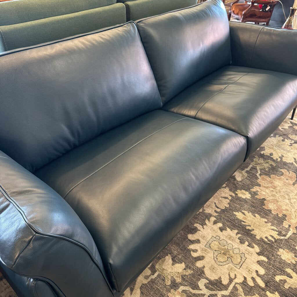 Gray leather sofa on a patterned rug