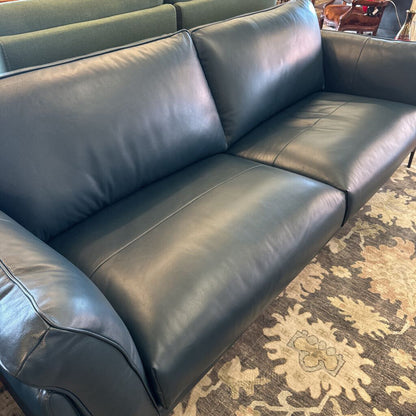 Gray leather sofa on a patterned rug