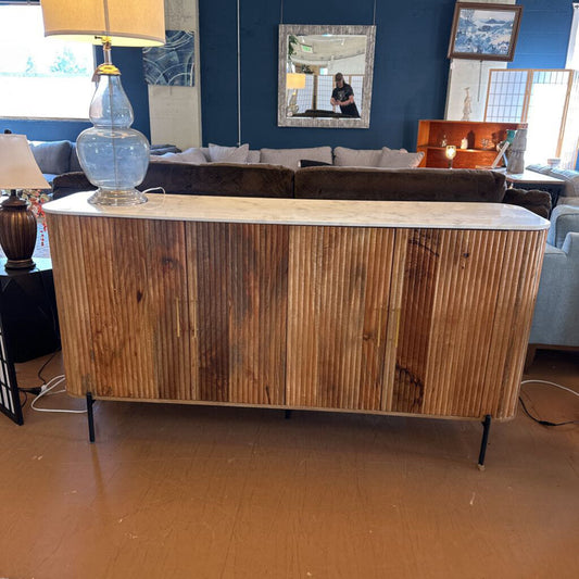 Wooden sideboard in a room with furniture and decor