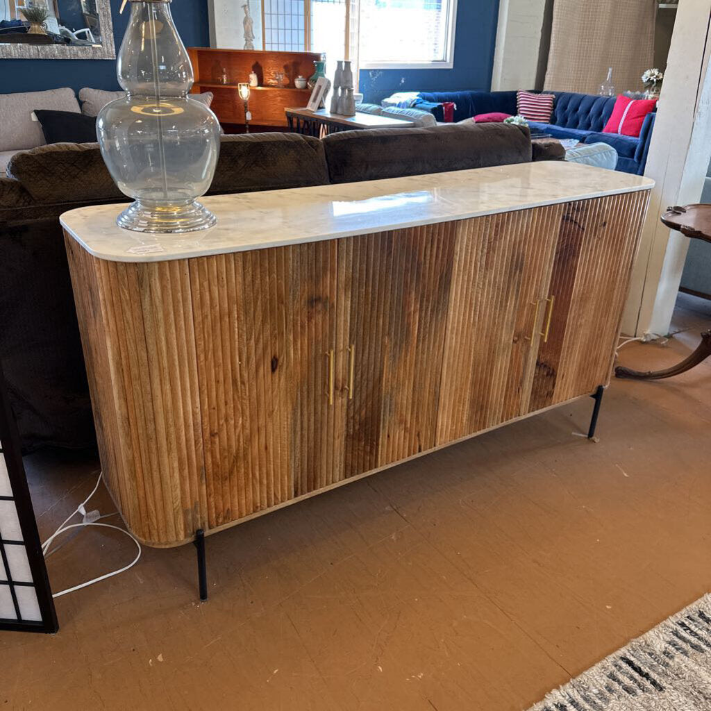 Wooden sideboard with marble top in a living room setting