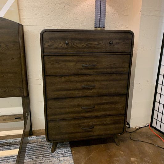 Wooden dresser with four drawers in a room setting