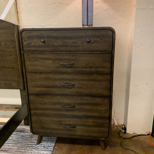Wooden dresser with four drawers in a room setting.