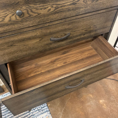 Wooden dresser with open drawer on a tiled floor
