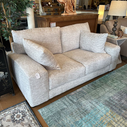 Gray sofa in a room with decorative elements and furniture.