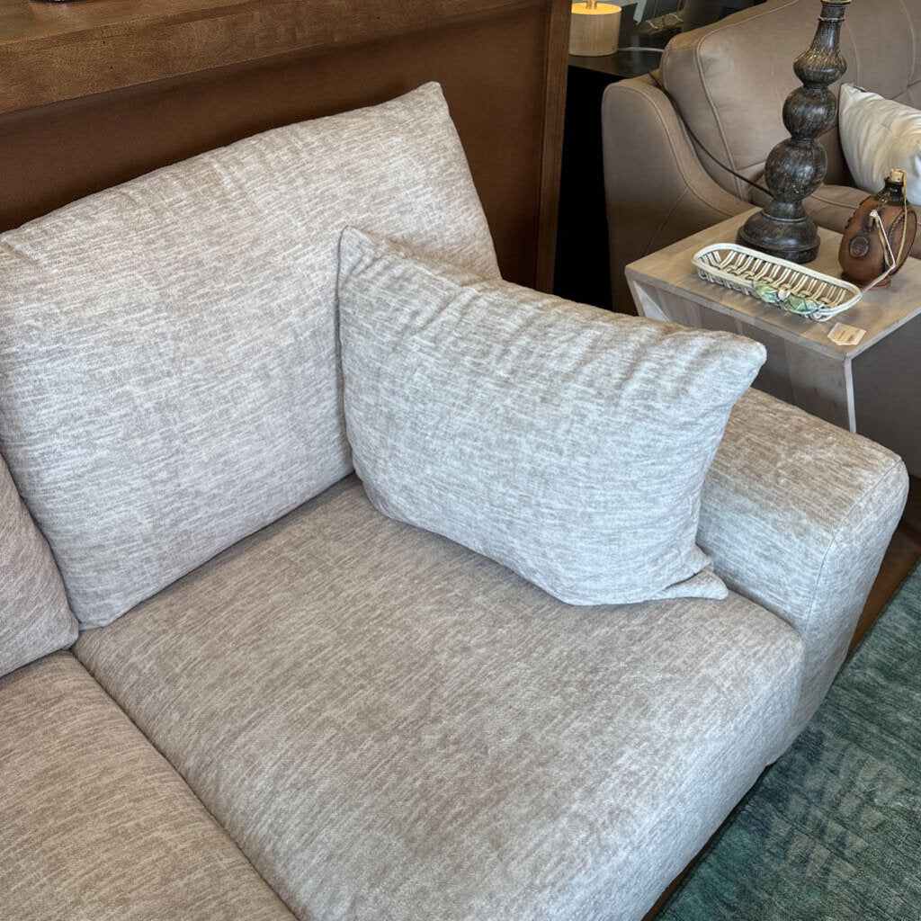 Gray sofa with decorative pillows in a living room setting