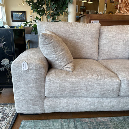 Gray sofa with a price tag in a store setting