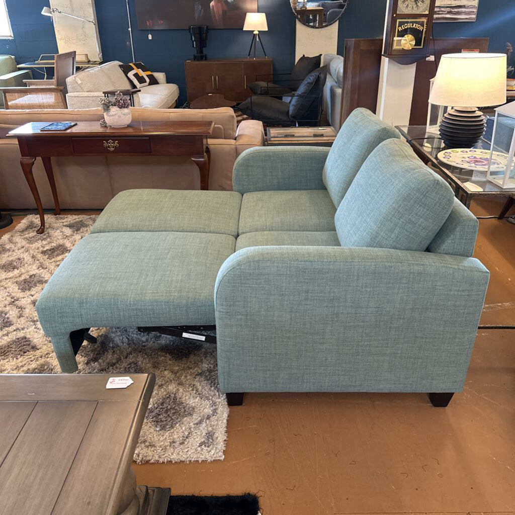 Blue sectional sofa in a room with furniture and decor