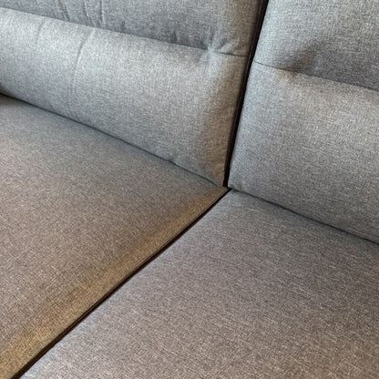 Gray fabric sofa corner with a textured pattern