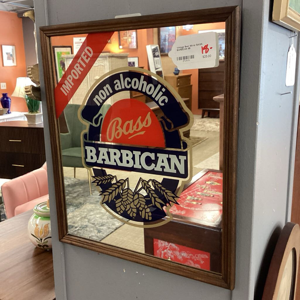 Decorative mirror with Bass Barbican non-alcoholic beer logo in a store setting