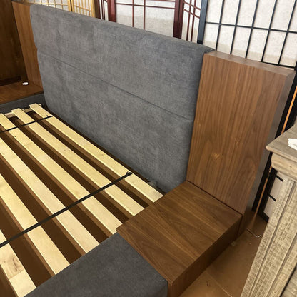 Wooden bed frame with gray upholstered headboard and wooden footboard.