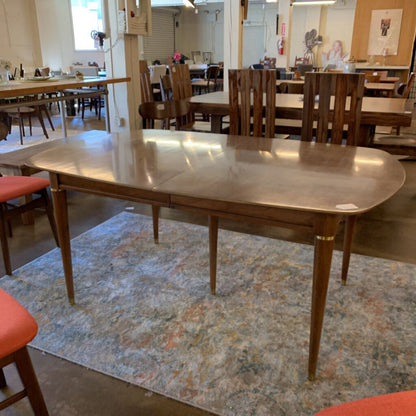 Wooden dining table with chairs in a room setting