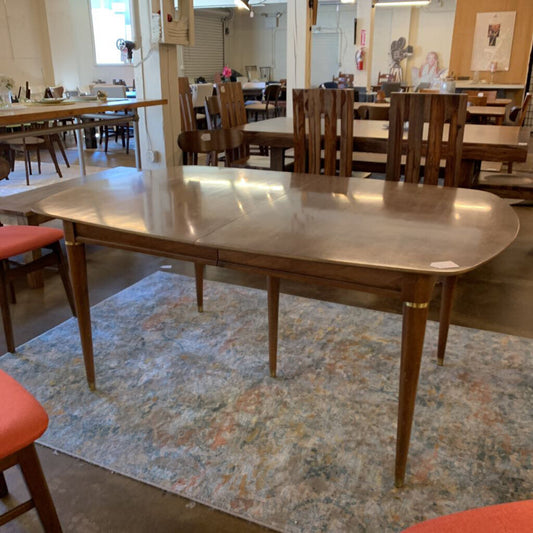 Wooden dining table with chairs in a room setting
