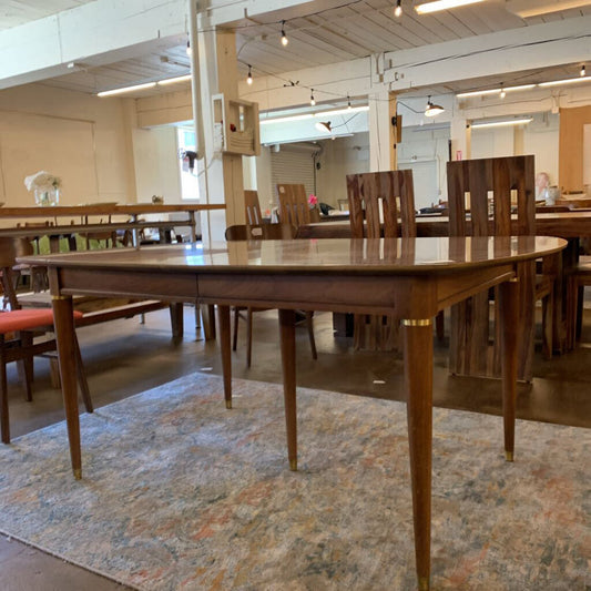 Wooden dining table with chairs in a showroom setting