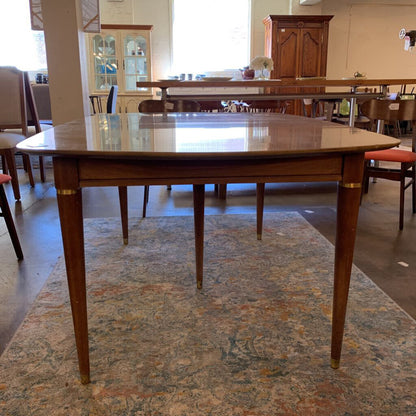 Wooden dining table in a room with chairs and cabinets